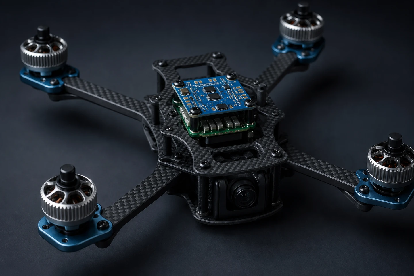 Quadcopter X-frame airframe assembled on a charcoal-grey backdrop